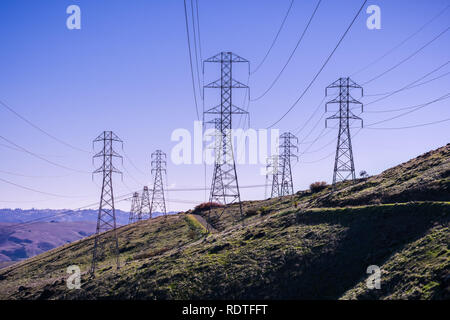 High voltage electricity towers on a blue sky background, San Francisco bay area, California Stock Photo