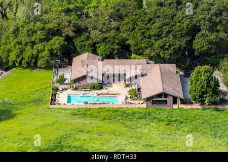 Aerial view of large house with pool surrounded by trees and green meadows, San Jose, Santa Clara county, south San Francisco bay area, California Stock Photo