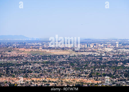 Aerial view of downtown San Jose on a clear day; residential neighborhoods in the foreground; San Francisco visible in the background; Silicon Valley, Stock Photo