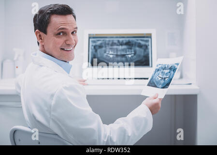 Joyful medical worker looking straight at camera Stock Photo
