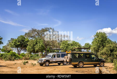 TSAVO EAST RESERVE, KENYA - OCTOBER 12, 2018: Safari cars on adventure trip in Tsavo East National Park, Kenya Stock Photo