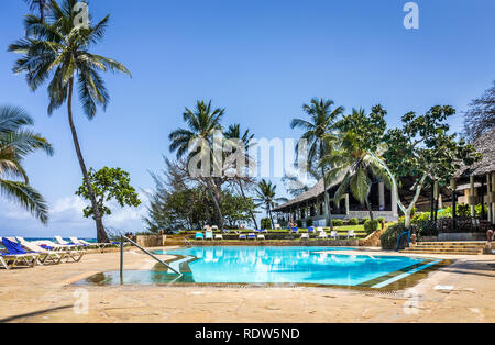 DIANI BEACH, KENYA - OCTOBER 09, 2018: Beautiful scenery of african luxury resort with empty swimming pool in the foreground, Kenya Stock Photo
