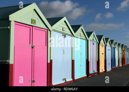 Coloured beach huts on Brighton & Hove seafront with old buildings behind, ENgland, UK Stock Photo