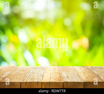 Empty of wood table top on blur of fresh green abstract from garden backgrounds.For montage product display or key visual layout Stock Photo