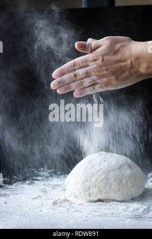 Making dough with flour by femae hands Stock Photo