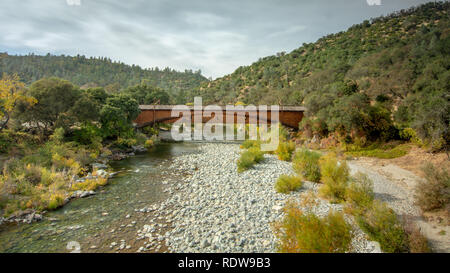 Side view of the bridgeport Covered Bridge at South Yuba River in California, USA, featuring the fall colors in the river. This bridge has the longest Stock Photo