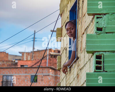 Dec 23 2018, Medellin Colombia - lady looking out from her house in Comuna 13 Medellin Stock Photo