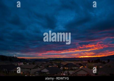 A colorful sky at sunset looking out over an American subdivision in the Pacific Northwest. Stock Photo