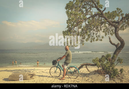 young man and woman in nature on the bicycle Stock Photo