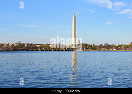Washington DC panorama during cherry blossom near Tidal Basin, USA. Blossoming cherry trees around Tidal Basin reservoir with Washington Monument in a Stock Photo