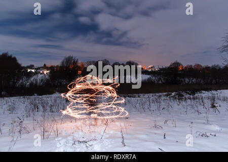 Long exposure. Yellow fire lines. Nightly winter landscape. The man is ...