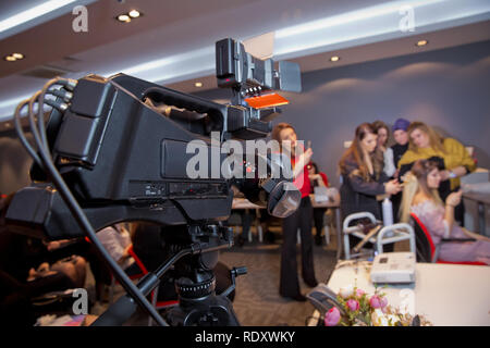 Makeup cosmetic at home. Focus on tripod mounted Video camera screen showing . In front of the camera to recording vlog video live streaming at home.B Stock Photo