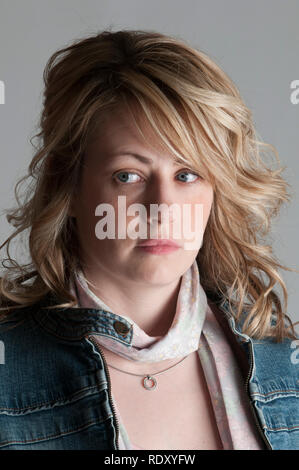 Serious blond woman looking away Stock Photo