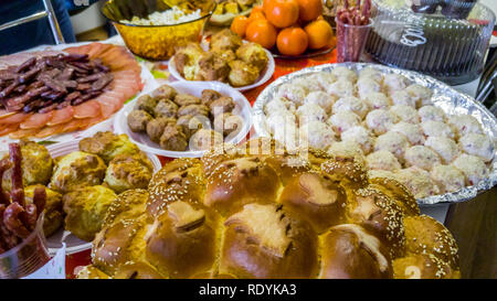 Rich table spread with many different dishes, fruits and deserts. Stock Photo