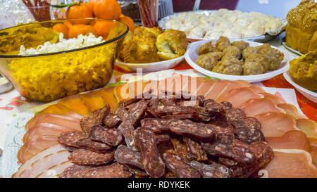 Rich table spread with many different dishes, fruits and deserts. Stock Photo