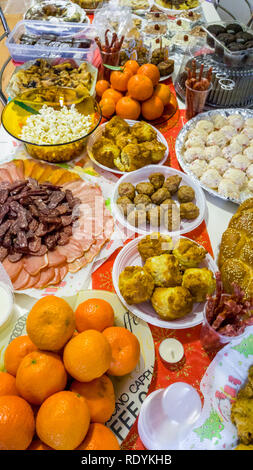 Rich table spread with many different dishes, fruits and deserts. Stock Photo