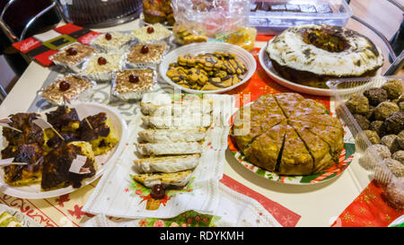 Rich table spread with many different dishes, fruits and deserts. Stock Photo