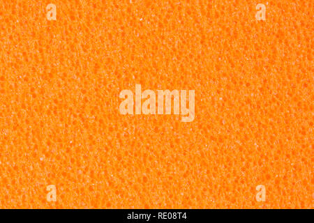 Saturated orange foam EVA texture with contrast porous surface. Stock Photo