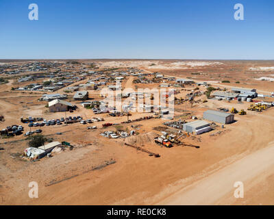 Aerial view of a small, remote desert town with buildings and vehicles under the clear sky Stock Photo