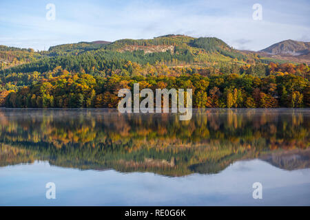 Early morning mist rising off Loch Faskally near Pitlochry, Perthshire, Scotland Stock Photo