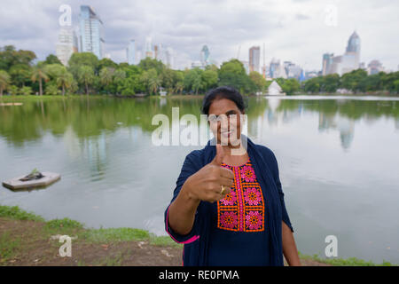 Mature beautiful Indian woman giving thumb up Stock Photo