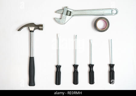 Top view of screwdrivers,hammer and wrench on white backdrop. Stock Photo