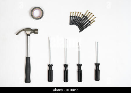 Top view of screwdrivers,hammer, screws, dowels on white backdrop Stock Photo