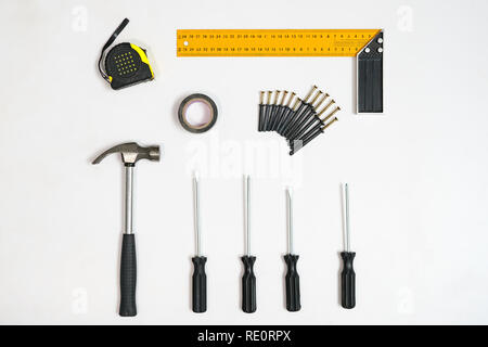 Top view of screwdrivers and tape measure on white backdrop Stock Photo