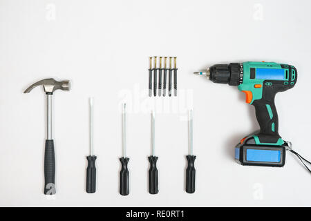 Top view of screwdrivers,hammer, screws and dowels on white backdrop Stock Photo