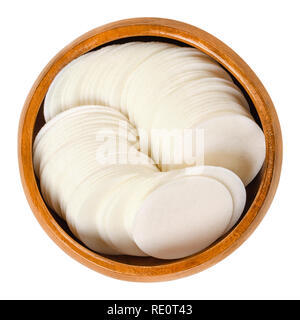 Round white wafer papers for baking in wooden bowl. Thin sheets, made of wheat flour and starch, for making cookies. Edible. Isolated macro food photo Stock Photo