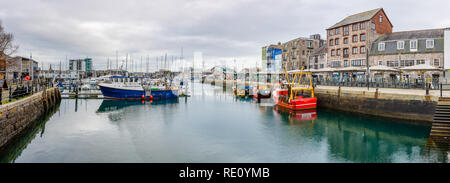 Boats Moored at the Barbican in Plymouth, Devon on calm day at high tide. Stock Photo