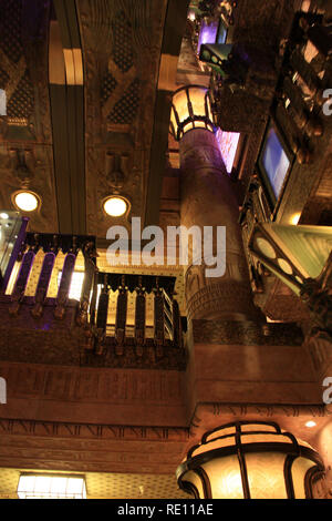 When entering the ancient Egypt themed escalator hall at Harrods, London, UK, people feel they enter a modern tomb chamber in an Egyptian pyramid Stock Photo