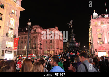 Crowd of people standing around the Shaftesbury Memorial Fountain at Piccadilly Circus in London, United Kingdom Stock Photo