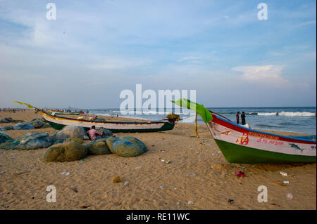 Fishing boats with fluttering flags on Marina Beach, Chennai, India Stock Photo