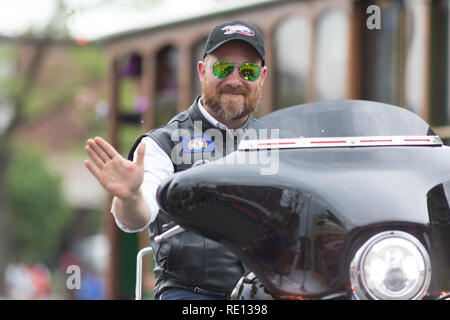 Louisville, Kentucky, USA - May 03, 2018: The Pegasus Parade, Man riding motorcycle waving for the camera Stock Photo