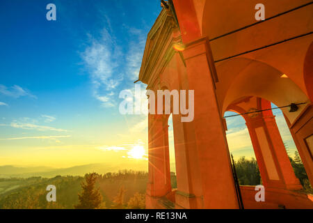 Arches of Sanctuary of Blessed Virgin of St. Luke on Colle della Guardia. Spectacular landscape of Bologna hills at sunset light. Famous pilgrimage destination in Emilia-Romagna, Italy, Europe. Stock Photo