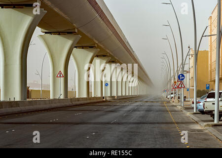 Riyadh Metro elevated rail disappearing into the distance during morning dust storm Stock Photo