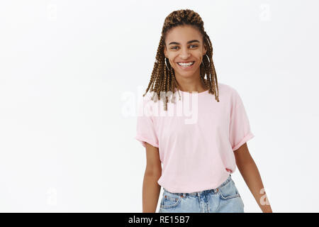 Waist-up shot of happy cute and tender attractive enthusiastic dark-skinned girlfriend with dreadlocks smiling broadly standing friendly and delighted Stock Photo