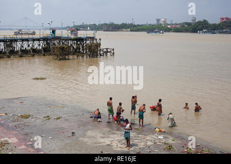 Kolkata / India - August 2015: Men taking a bath in the hooghly river. Stock Photo