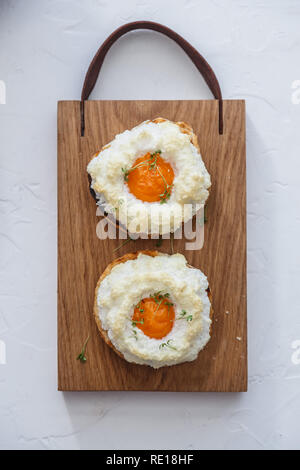 French breakfast with orsini eggs on wooden background, flat lay Stock Photo