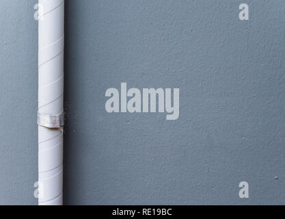 Drain pipe with with the white tape from the air compressor unit on the house wall,(copy space). Stock Photo