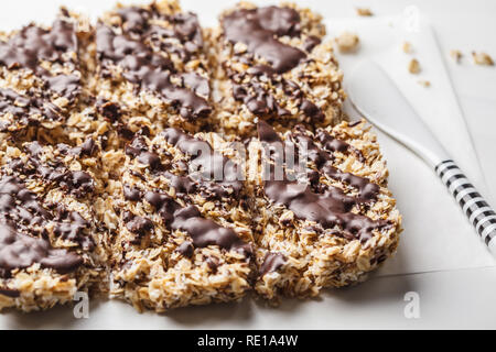 Homemade chocolate oat bars on a white background. Healthy vegan dessert, detox food, plant based. Stock Photo