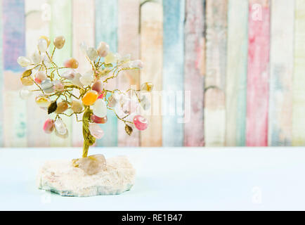 Feng shui gem tree, also called feng shui crystal tree is used for spiritual feng shui cures for love to feng shui for money. Isolated on colorful pas Stock Photo