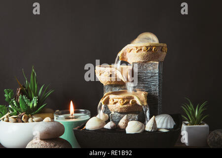 Portable indoor fountain for good Feng Shui in Your Home concept. Portable indoor small tabletop fountain. Spiritual mind and soul balance concept. Gr Stock Photo