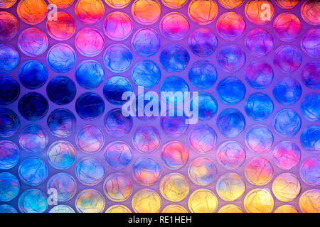A bright multicolored image taken through a sheet of plastic bubble wrap Stock Photo