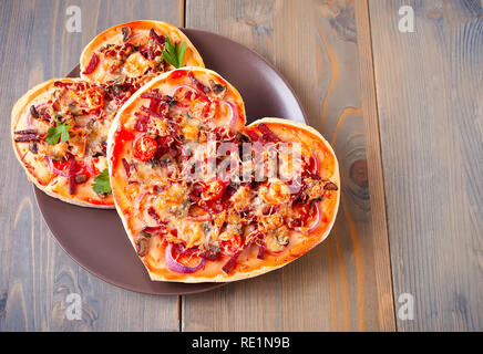 Pizza in the shape of heart for Valentine's Day Stock Photo