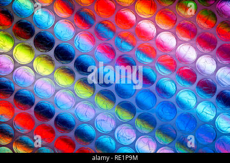 A bright multicolored image taken through a sheet of plastic bubble wrap Stock Photo