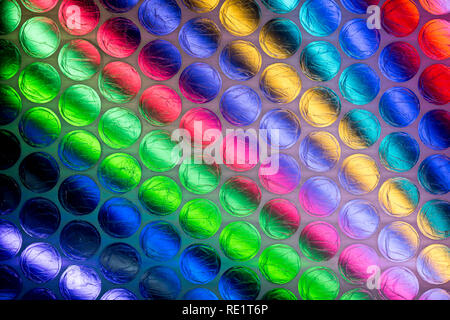 A bright multicolored image taken through a sheet of plastic bubble wrap Stock Photo