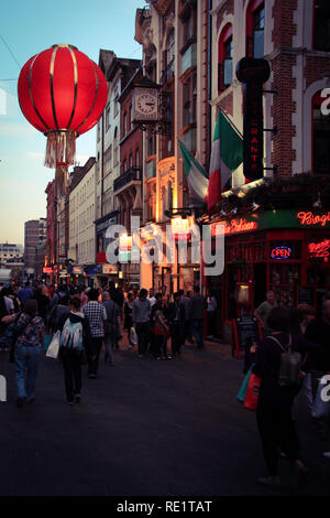 Lots of people walking through the pedestrian zone at Wardour Street in China Town, London, United Kingdom Stock Photo