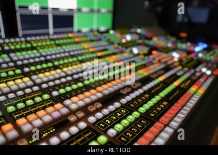 Broadcast Video Switcher used for live events and television production, with colorful lights and buttons Stock Photo